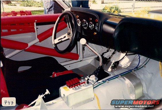 Racing interior with roll cage, racing seat, and floor shifter