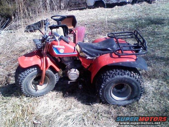 Red 1983 Honda 200 ES BIG RED three-wheeler parked outside