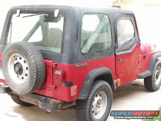 1988 Jeep YJ Wrangler, red with black soft top, spare tire on rear door, visible rust on lower body panels