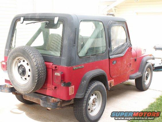 Red 1988 Jeep Wrangler YJ, 3/4 front view with spare tire on rear