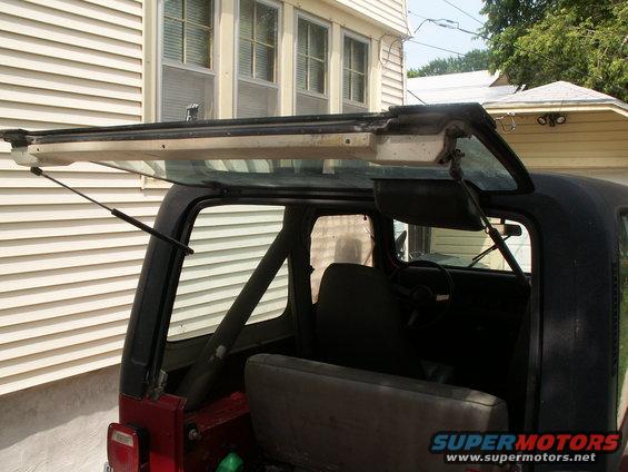Red Jeep YJ rear interior with roll cage and open hardtop