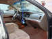2001 Mercury Grand Marquis - The interior of a 2001 Mercury Grand Marquis features tan upholstery and wood trim accents.