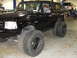 1995 Ford Bronco - Black 1995 Ford Bronco modified with dual rear tires, parked indoors.