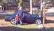 1998 Ford Crown Victoria - A green 1993 Ford Mustang coupe is parked on a lawn with two people standing next to it.