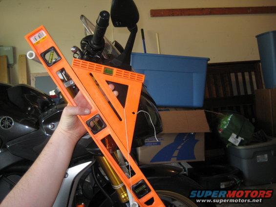 Motorcycle front end with orange level tool for fork alignment