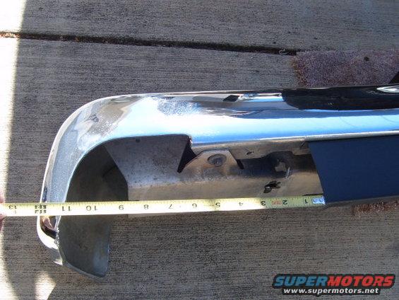 chrome bumper being measured with a tape measure