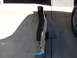 1973 Ford Ranchero - A chrome bumper with a black rubber strip is shown from the side on a concrete surface.