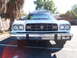 1973 Ford Ranchero - The front end of a white pickup truck is shown, a large grille and dual headlights.