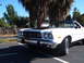 1973 Ford Ranchero - White 1973 Ford Ranchero pickup with a black hood parked outdoors.