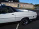 1973 Ford Ranchero - Side profile of a white 1973 Ford Ranchero pickup truck with a black vinyl roof.