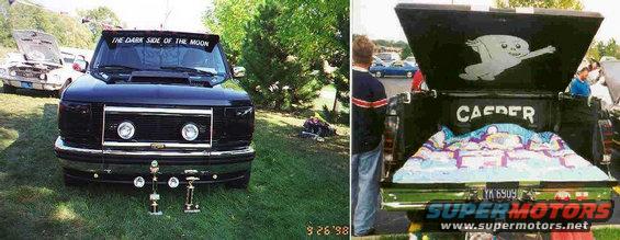Black Ford F-150 truck front view with "THE DARK SIDE OF THE MOON" text on windshield and trophies