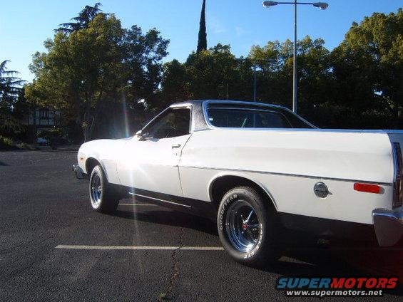 White 1973 Ford Ranchero side view with black stripe and chrome wheels