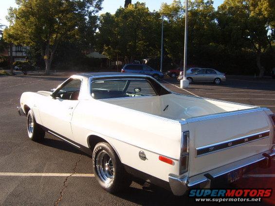 1973 Ford Ranchero parked, rear 3/4 view. Cream exterior, black vinyl top