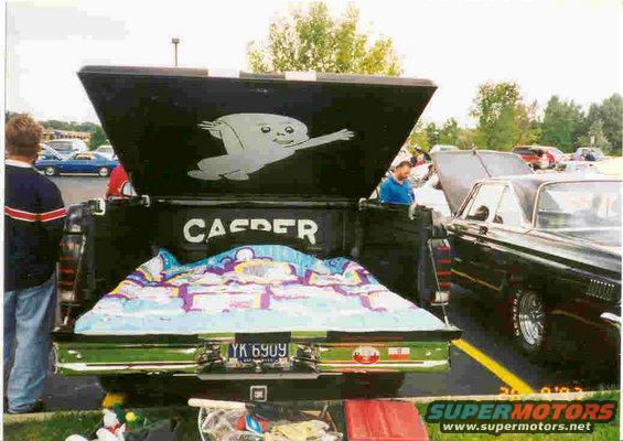 Black pickup truck bed with Casper mural, colorful blanket, and license plate YK 6909