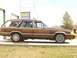1984 Ford LTD - Station wagon with wood paneling parked outside a building.