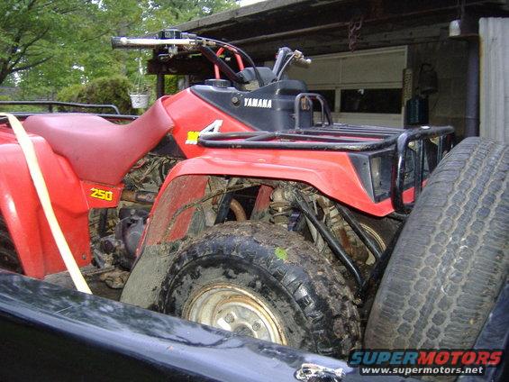 Red Yamaha ATV with '250' and 'Yamaha' visible, loaded in a truck bed