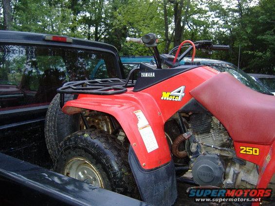 1989 Yamaha MOTO-4 250 ATV loaded in a pickup truck bed