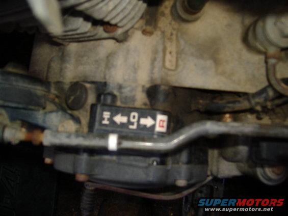 Gear selector lever with H, 4, 9, and R indicators. Part of an engine or transmission