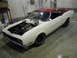 1969 Mercury Cyclone - A white 1969 Mercury Cyclone coupe with a red roof and exposed engine is parked in a garage.