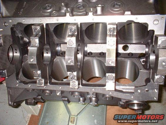 Engine block showing crankshaft bearing saddles and main caps