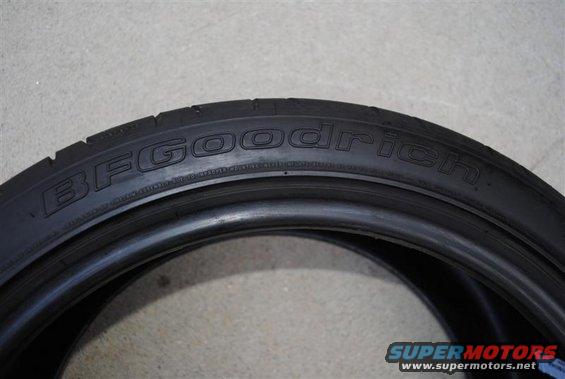 BFGoodrich tire with black sidewall and tread visible against a gray background
