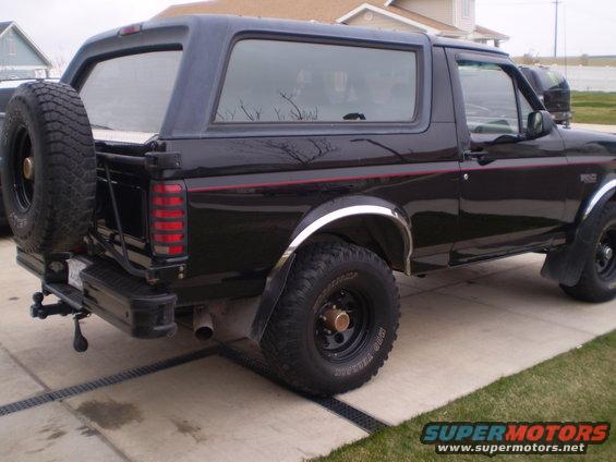 1996 Ford Bronco, rear view, black paint, spare tire mounted on swing away carrier
