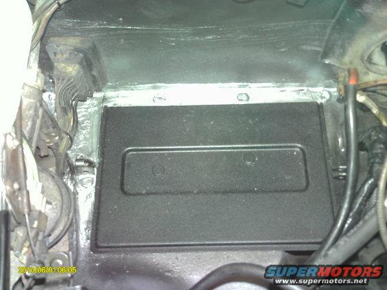 pict0025.jpg Took out battery tray, removed rust and refinished with truck bed liner from aerosol can. Silicone sealer in the seams.