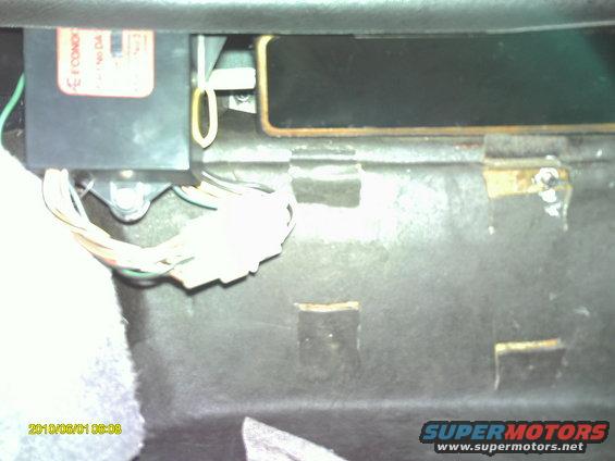 Looking up from passenger side footwell, the square cuts in the sound deadener panel were made for access to the nuts under the battery tray, so tray could be removed.