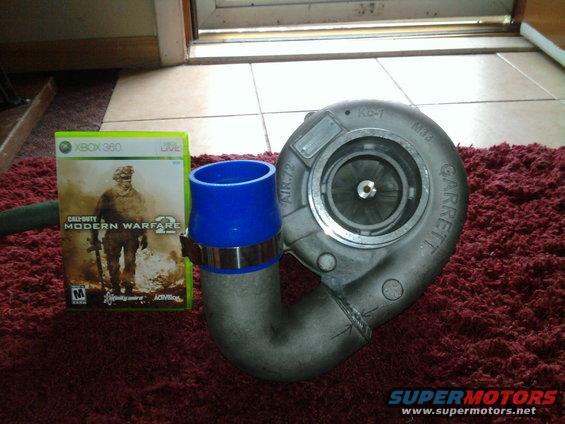 Garrett turbocharger with blue intake pipe and Xbox 360 game case