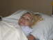 2001 Pontiac Trans Am - A woman lies in a hospital bed, wearing a striped newborn cap.