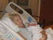 2001 Pontiac Trans Am - A woman cradles her newborn baby while lying in a hospital bed, with a watermark indicating the image source.