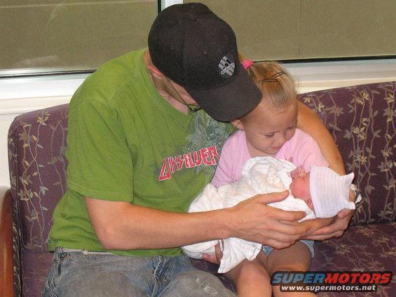 Family holding a newborn baby