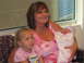 2001 Pontiac Trans Am - A woman holds a newborn baby while a young girl sits beside her.