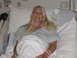 2001 Pontiac Trans Am - A woman rests in a hospital bed, wearing a gown and bracelets. Medical equipment is nearby.