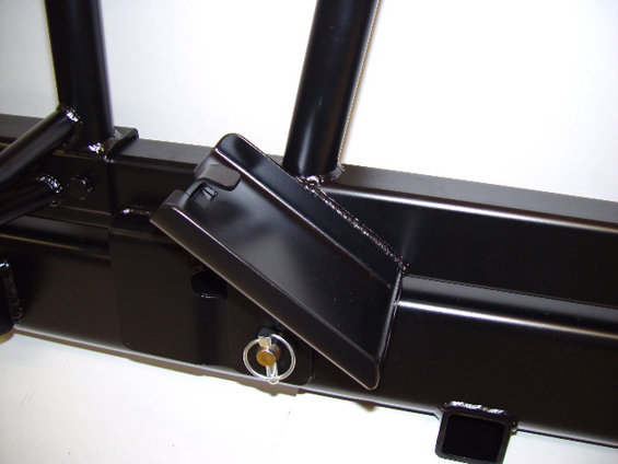 Close-up of a black aftermarket rear bumper with a step and a pin