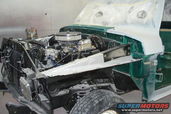 1979 Ford F-150 engine bay with engine removed for restoration, green body panels visible