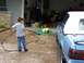 1989 Ford Bronco - A child is washing a blue convertible with a white top in a driveway.