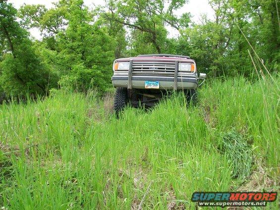 1988 Ford F-150 front view with brush guard in tall grass
