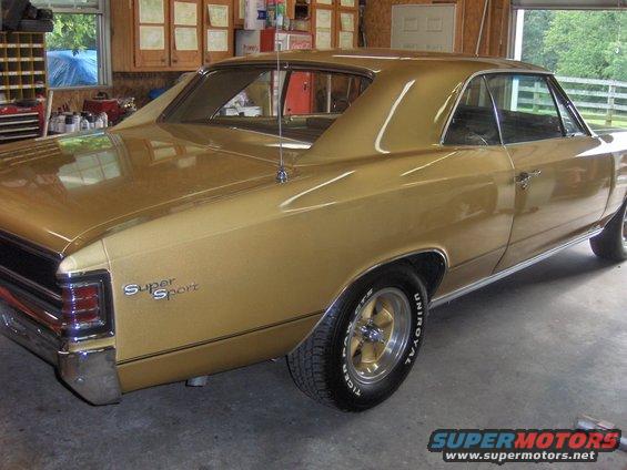 Gold 1967 Chevrolet Chevelle SS coupe in a garage. Has 'Super Sport' badging on the rear quarter panel