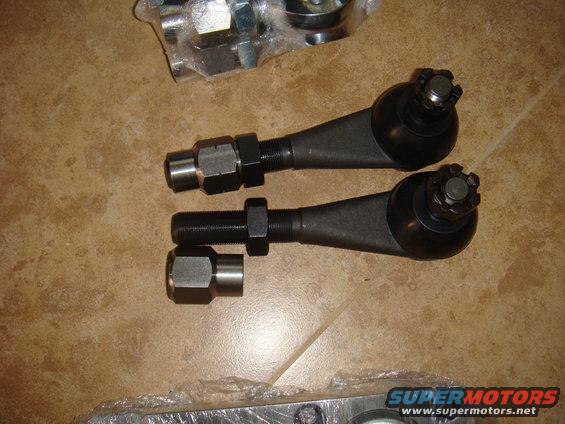 Two tie rod ends with nuts and a separate nut and sleeve. Supermotors.net logo visible