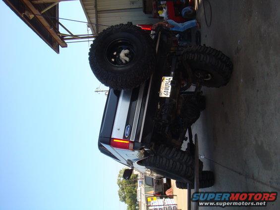 1992 Ford Bronco rear view with large off-road tires and spare tire mounted