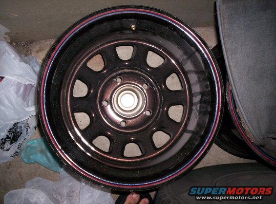 Black wheel with red and blue trim, close-up view