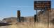 2002 Ford F-250 - Sign warns of potential smuggling and illegal immigration in this remote desert area.
