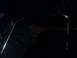 1995 Ford Bronco - A partial view of a vehicle's chrome trim is visible in the darkness.
