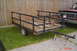 2002 Suzuki VL 1500 Intruder Classic - Utility trailer and a red pickup truck are parked in front of a wooden fence.