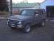 1984 Ford Bronco II - A 1984 Ford Bronco II is shown from a three-quarter front angle, parked in front of a garage and house.