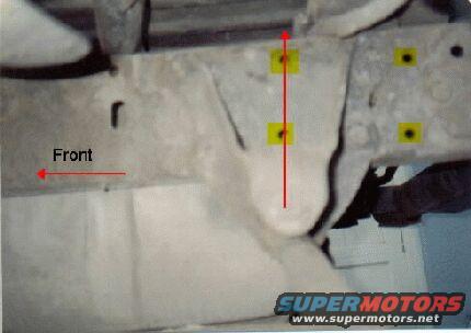 This is a view of the flip on the driver's side of Chris Gzybowski's Bronco.  Note the yellow holes indicate where the stock hanger was.  The pivot of the new hanger is in line vertically with the forward set of old holes; this will produce a good shackle angle