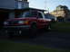 1997 Ford Ranger - A red pickup truck is parked in a driveway next to a house.