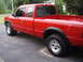 1997 Ford Ranger - Red 1997 Ford Ranger pickup truck seen from a 3/4 front angle on a driveway.