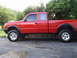 1997 Ford Ranger - This red Ford Ranger pickup truck is shown from the side, an extended cab and a long bed.